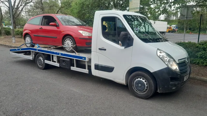 Car loaded onto a recovery truck for scrap collection in Lancaster