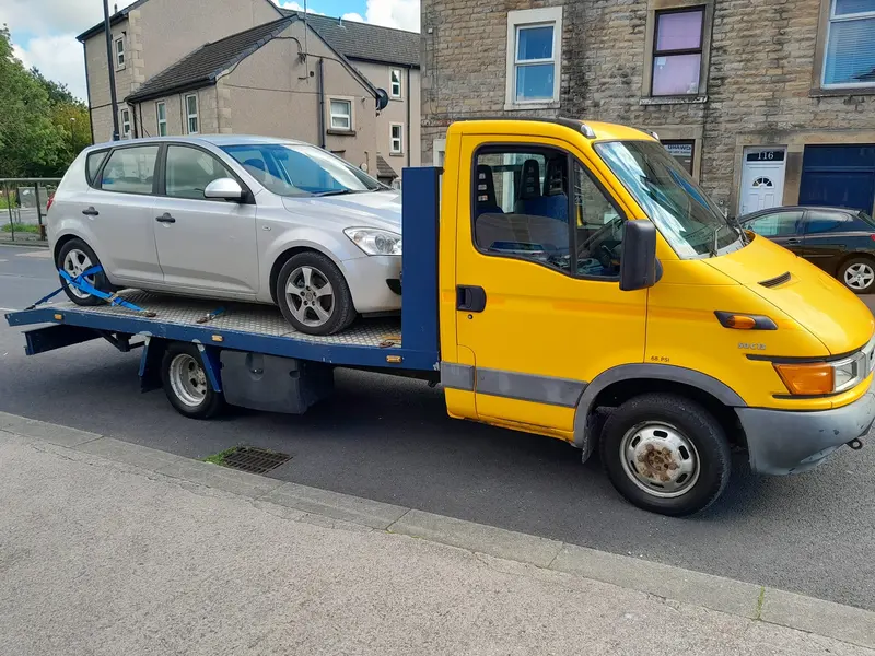 Scrap car on a recovery truck in Lancaster